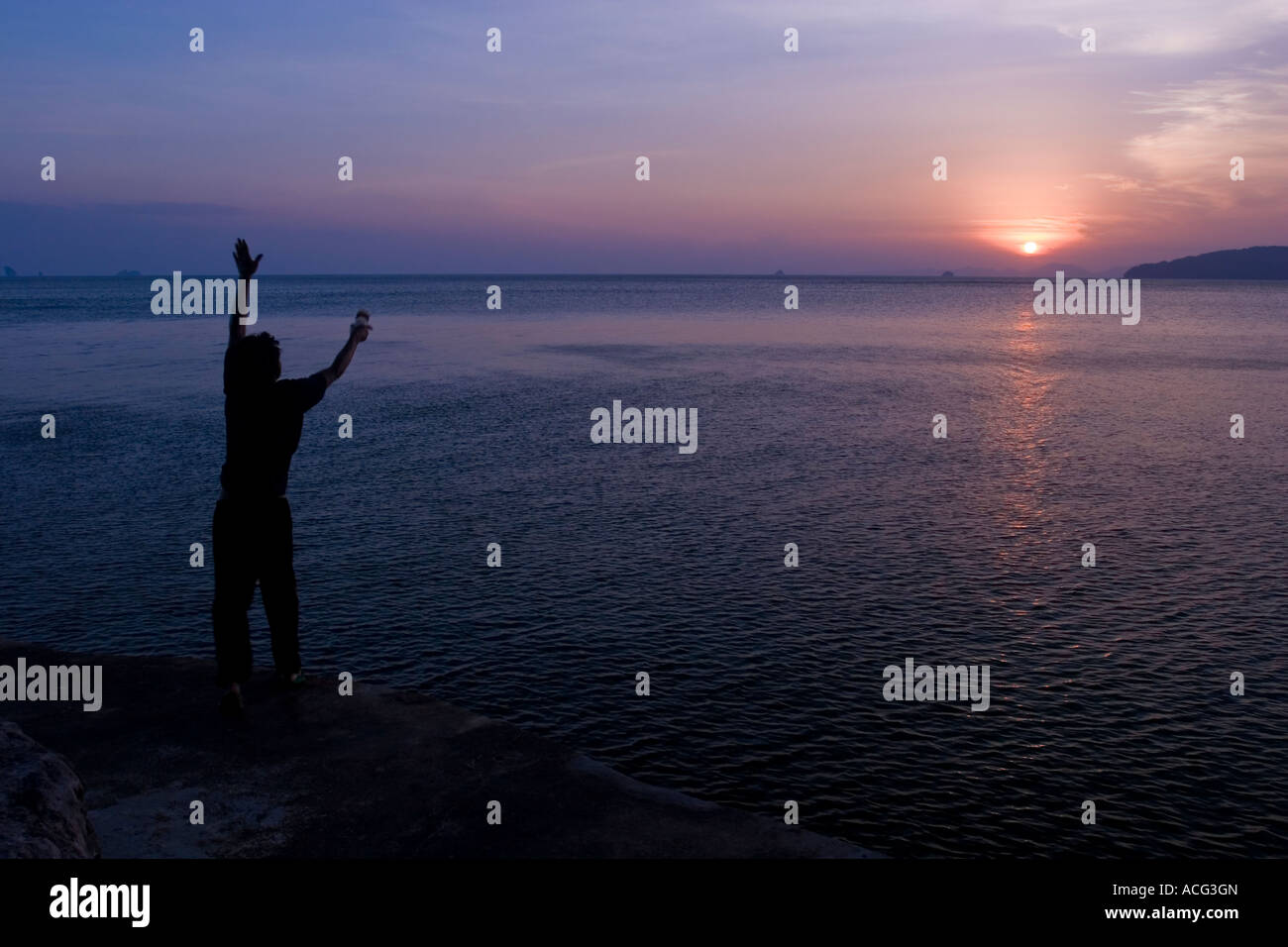 Fisherman at sunset Ao Nang Thailand Stock Photo - Alamy