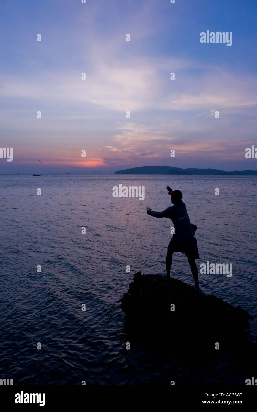 Fisherman at sunset Ao Nang Thailand Stock Photo - Alamy