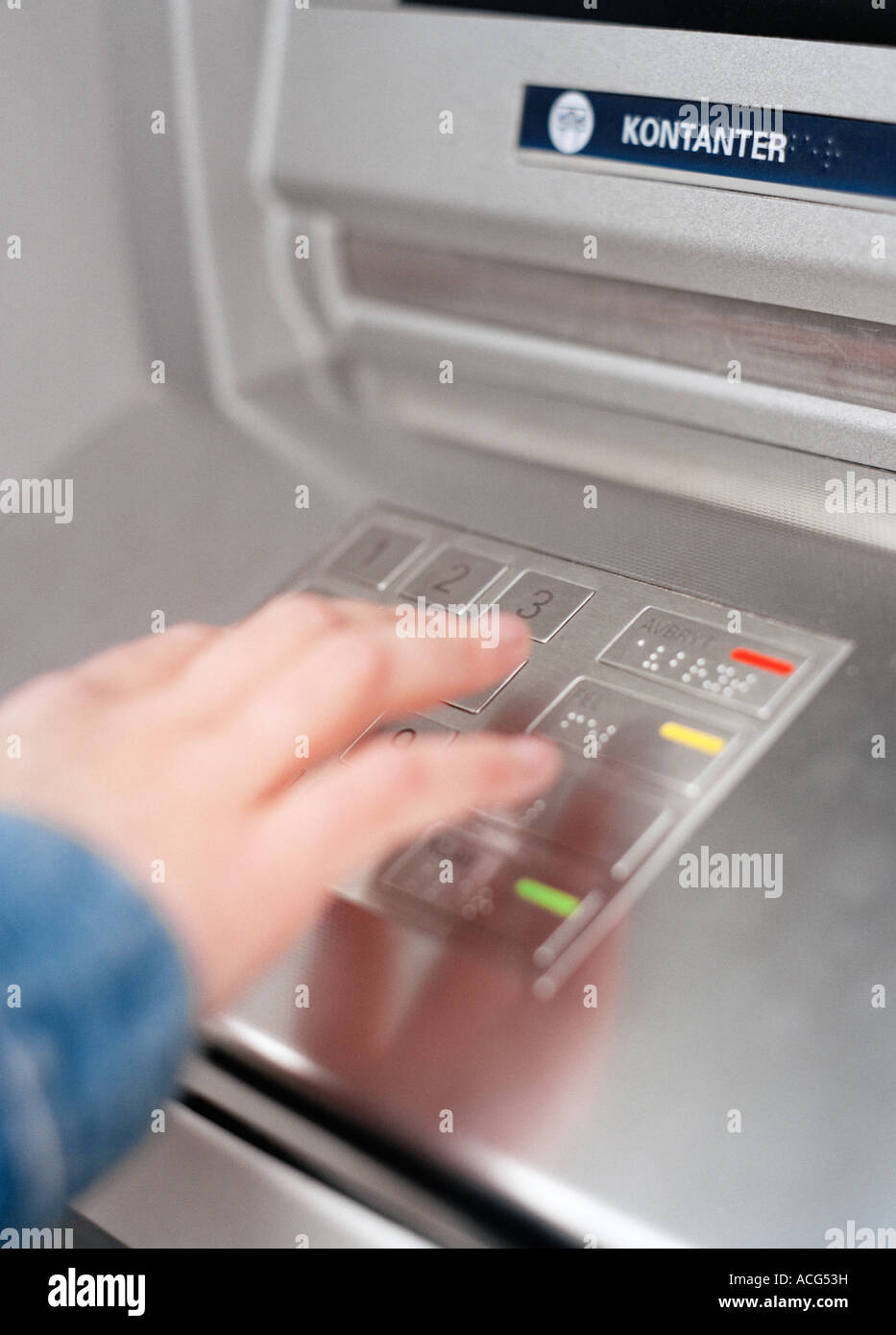 A person inserting his code in a cash-dispenser Stock Photo - Alamy