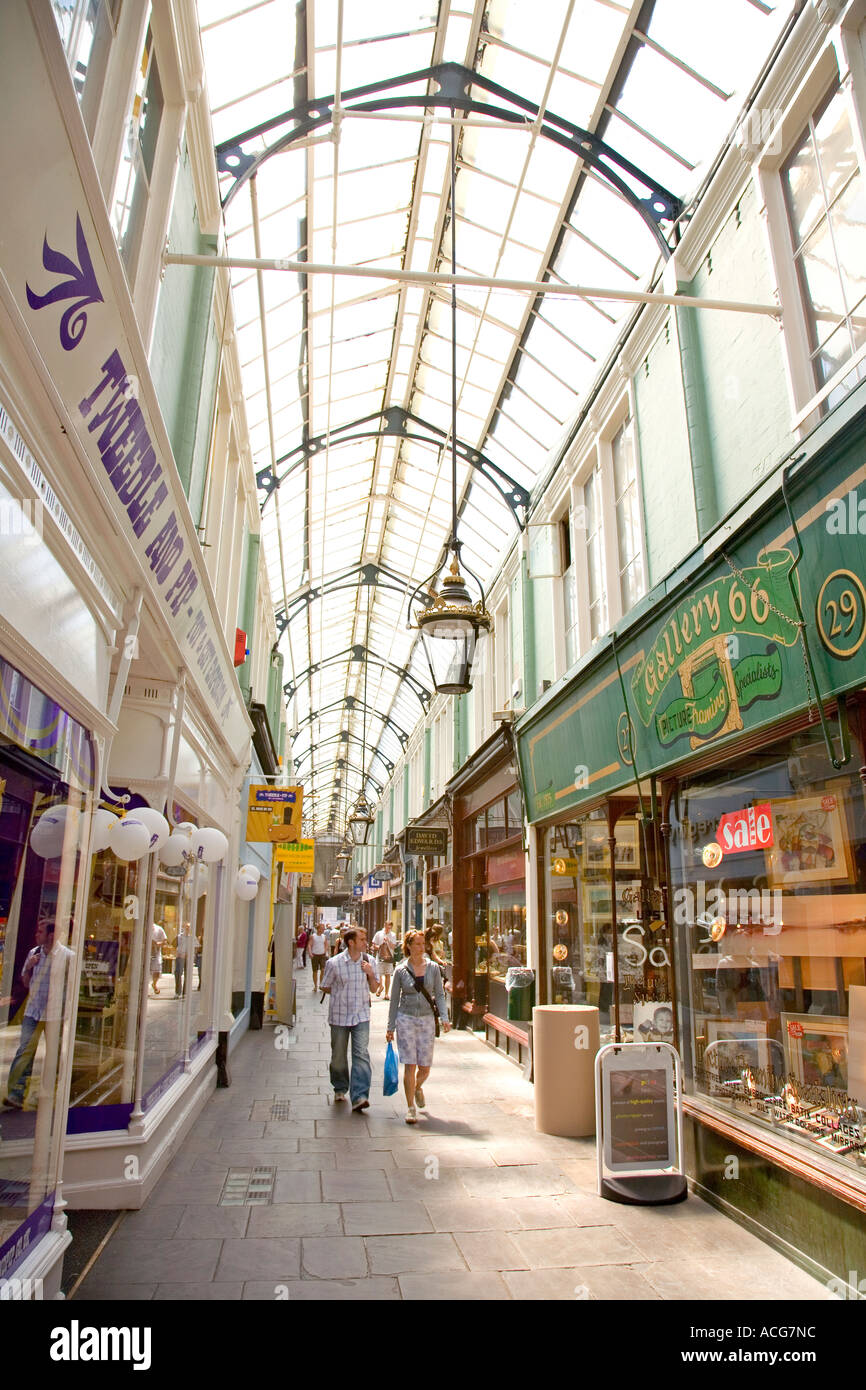 Shoppers in the Victorian era Royal arcade in city centre shopping area Cardiff Wales UK Stock Photo