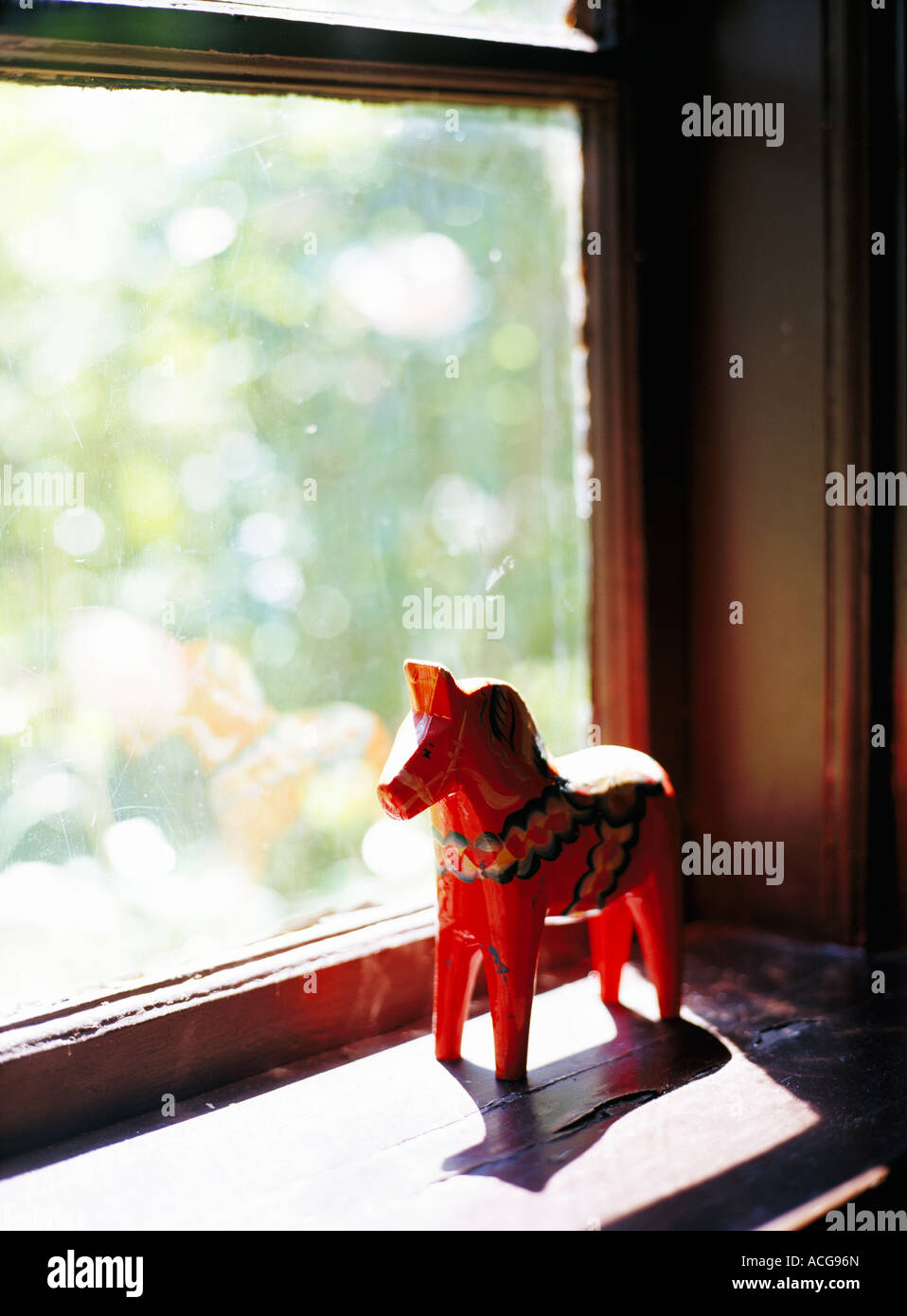 A Dalecarlian horse in a windowsill. Stock Photo