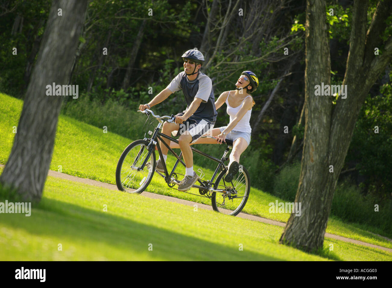 Happy couple on a tandem bike Stock Photo