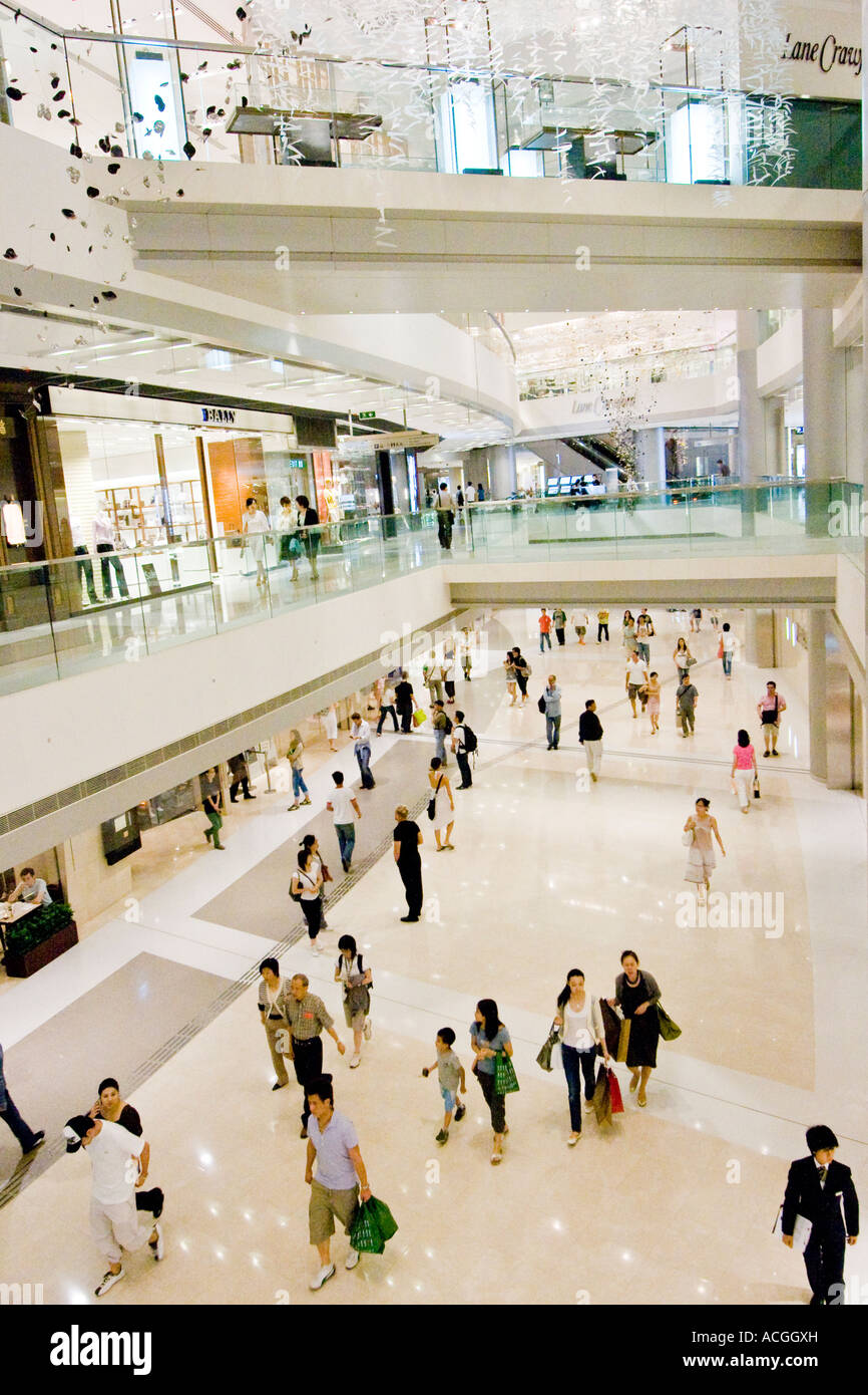 Shoppers inside Multi Level Shopping Centre Mall IFC International Finance Centre Hong Kong China Stock Photo