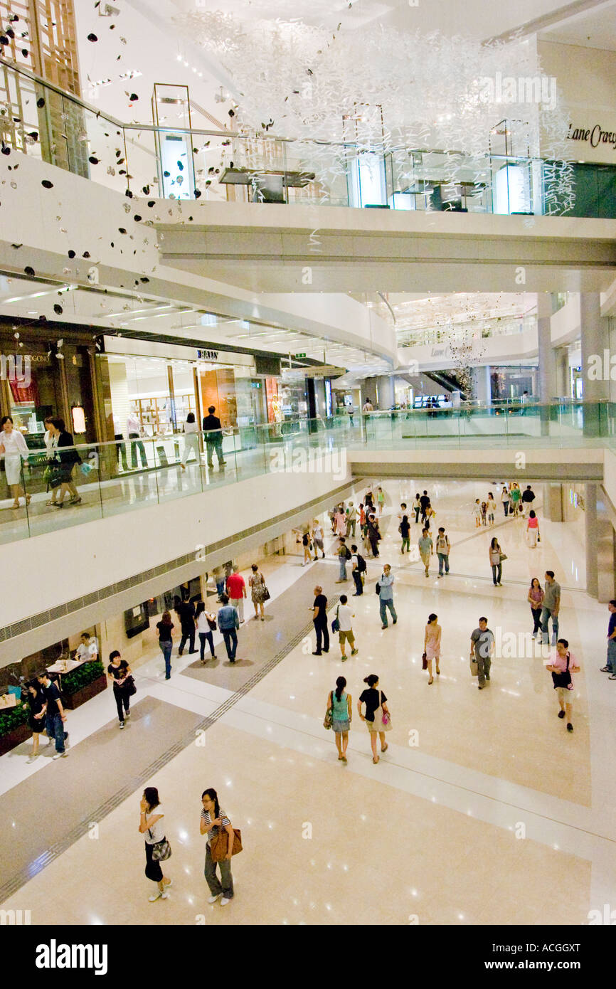 Shoppers inside Multi Level Shopping Centre Mall IFC International Finance Centre Hong Kong China Stock Photo