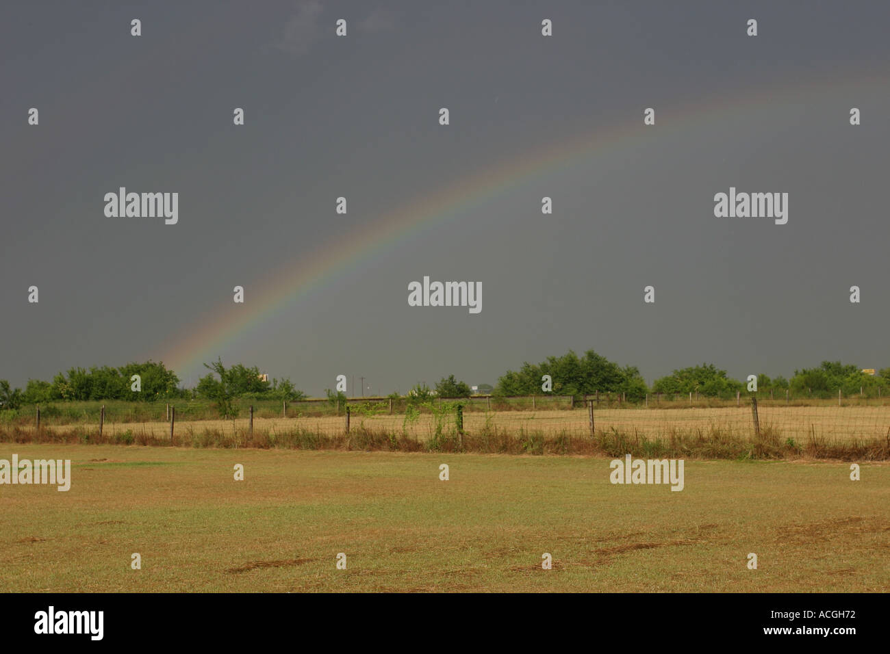 Rainbow in a dry field after an afternoon thunderstorm Stock Photo - Alamy