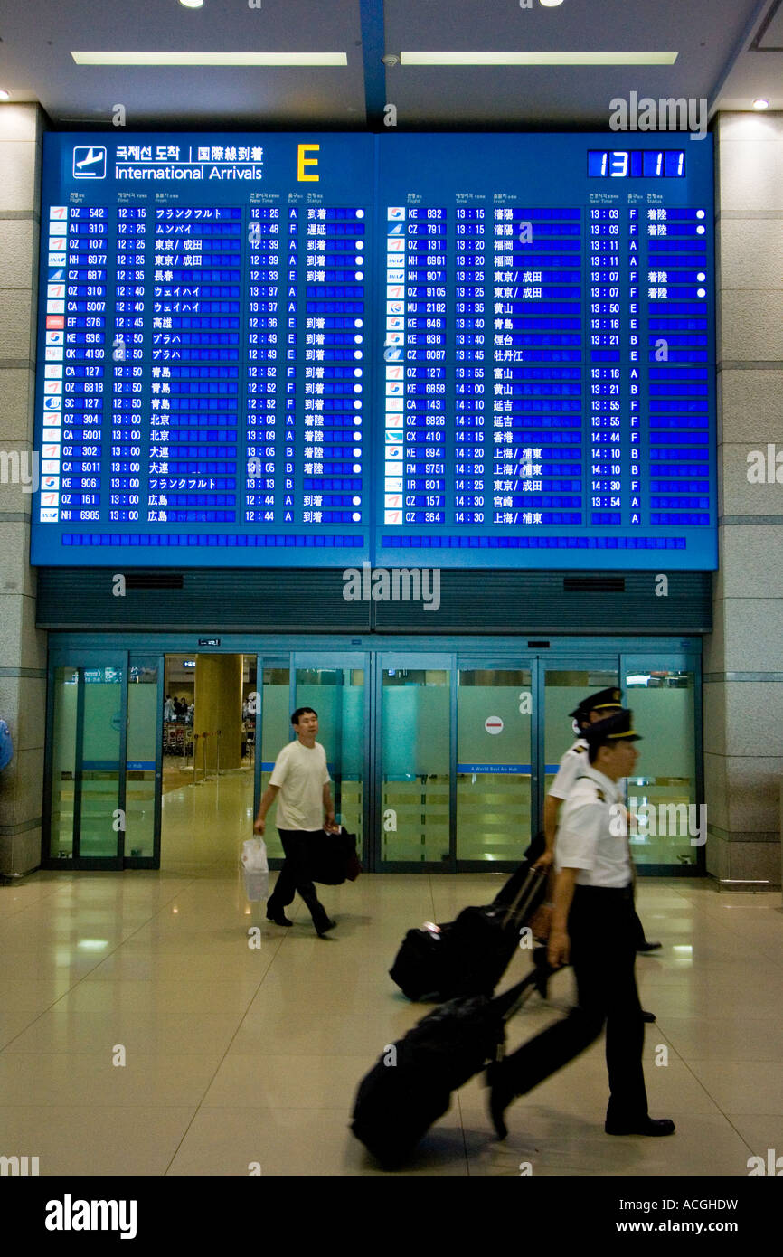 Passengers Enter Arriving Area under Arrivals Board Grand Incheon International Airport ICN Seoul South Korea Stock Photo