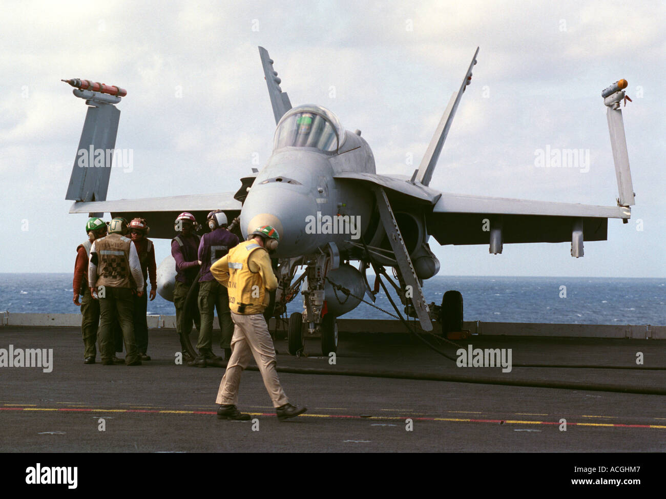 Flight deck officers prepare to launch a U.S. Navy F/A18C