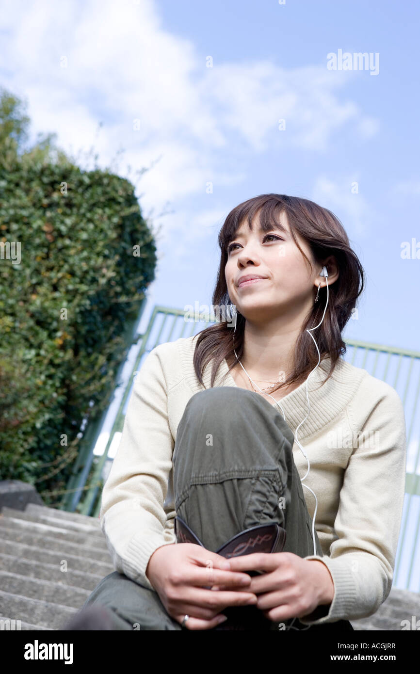 Asian woman wearing earphones hi-res stock photography and images - Alamy
