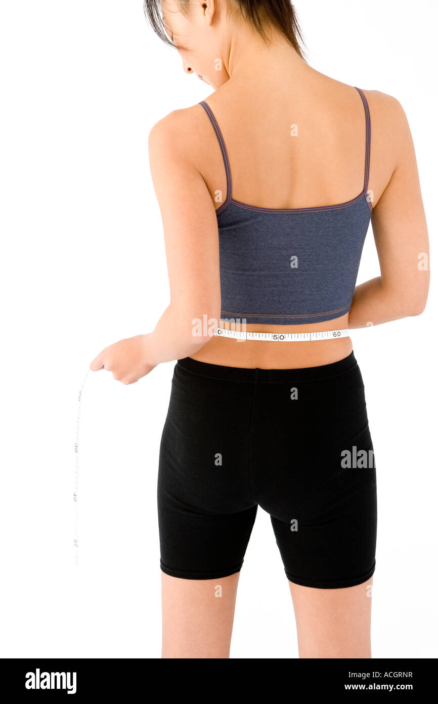 Woman measuring her waist Stock Photo