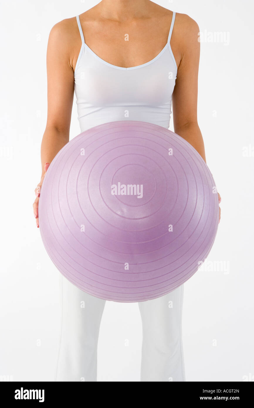 Woman holding fitness ball Stock Photo - Alamy