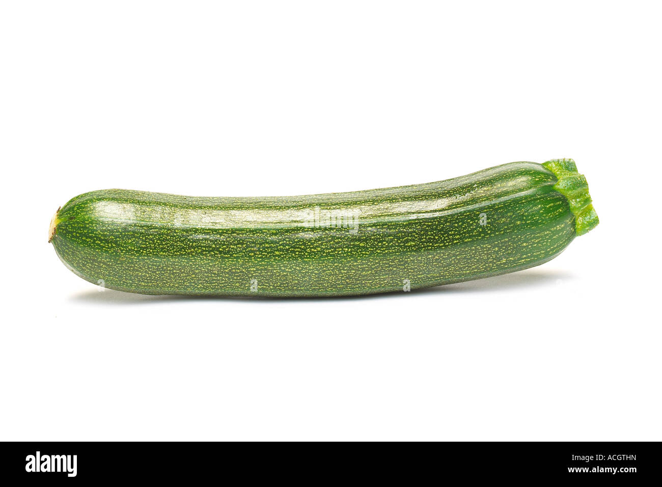 A fresh ripe green whole courgette on white background Stock Photo