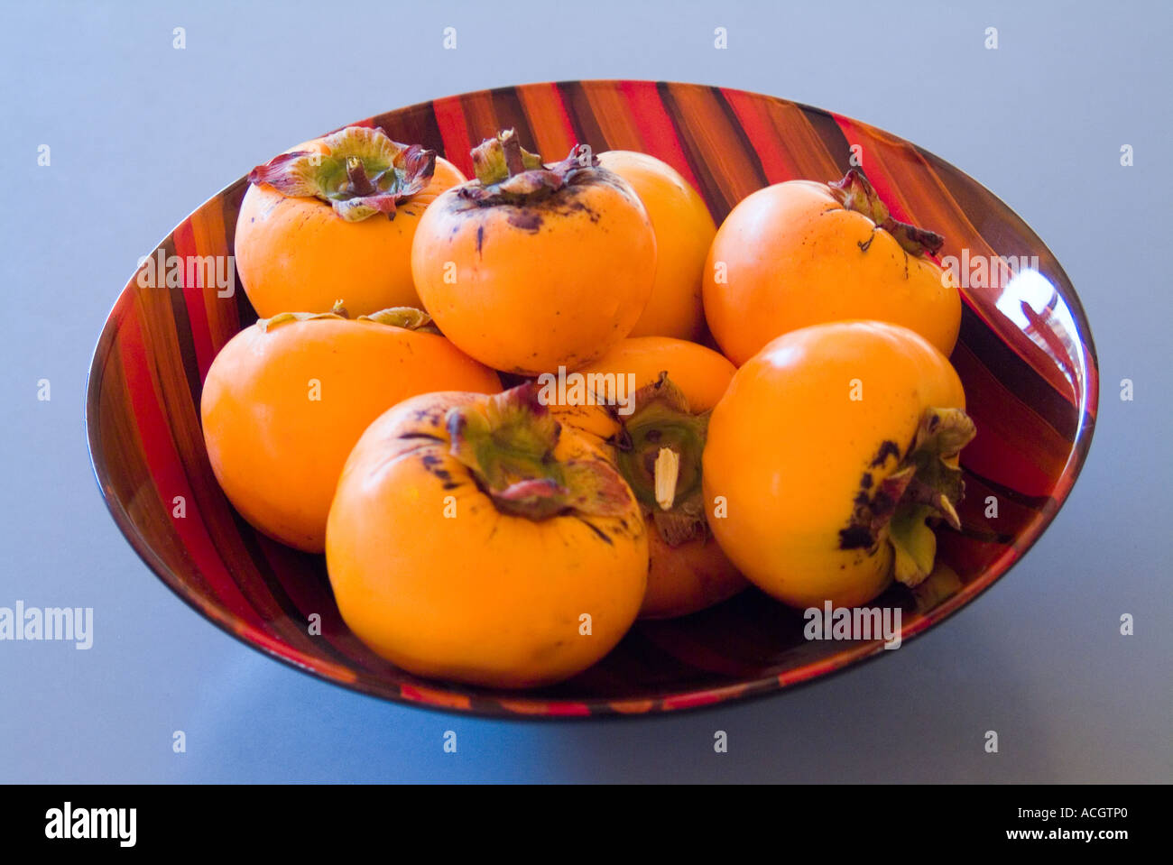 Persimmon in a lacquer bowl Stock Photo