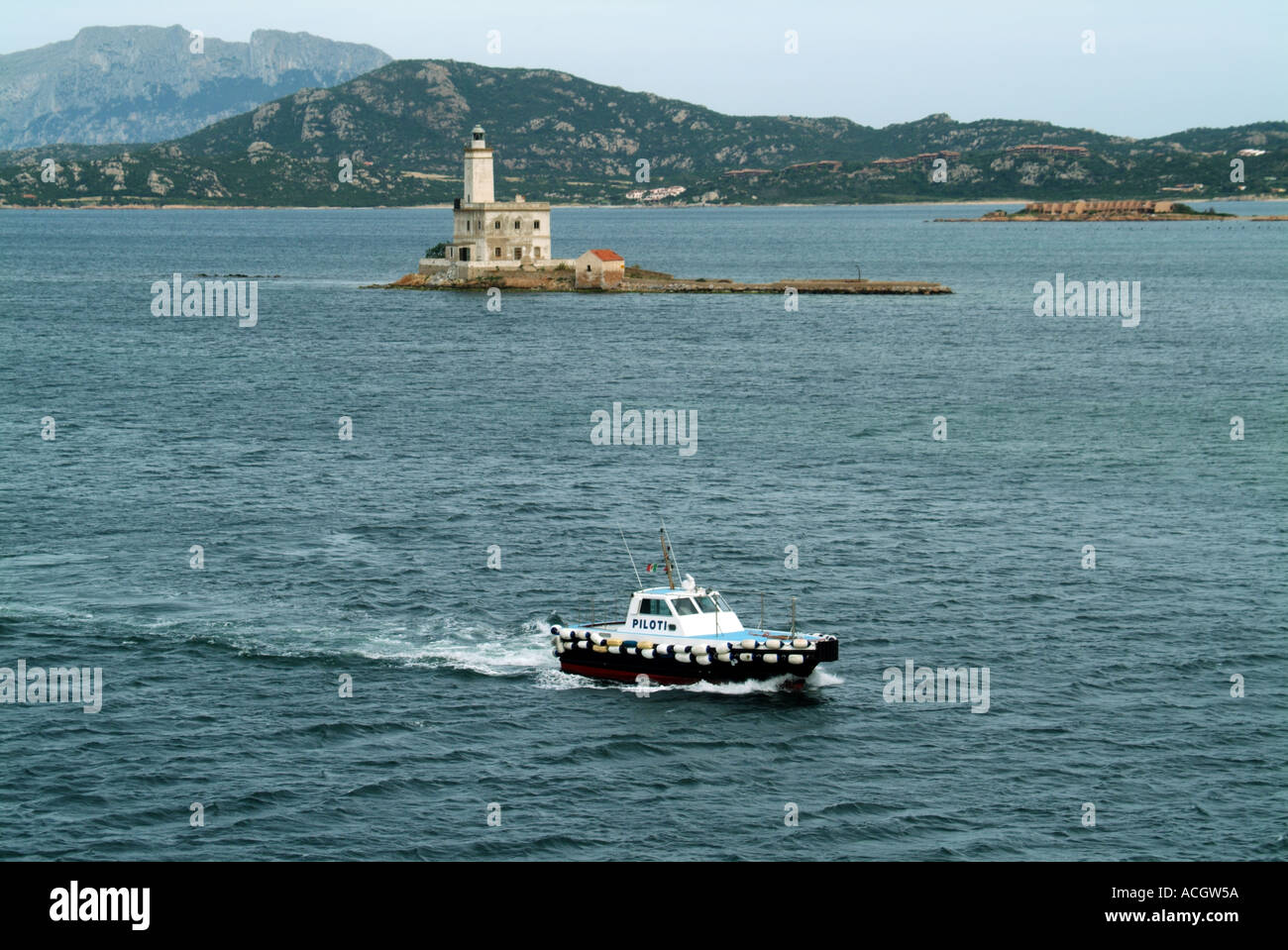 Olbia Sardina port approaches and lighthouse with pilot launch arriving Stock Photo