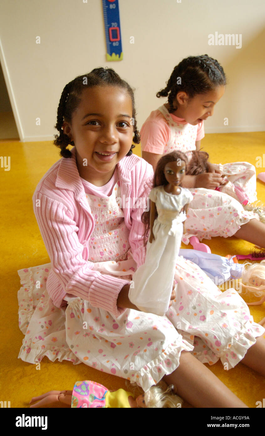 Two girls playing with dolls Stock Photo