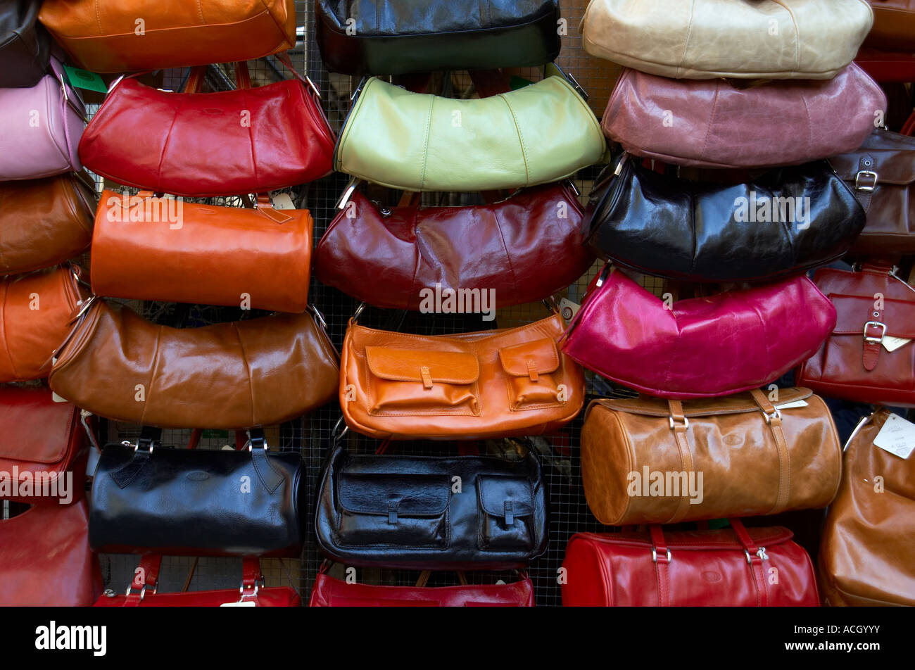 Display of leather purses of various colors in an outdoor market in