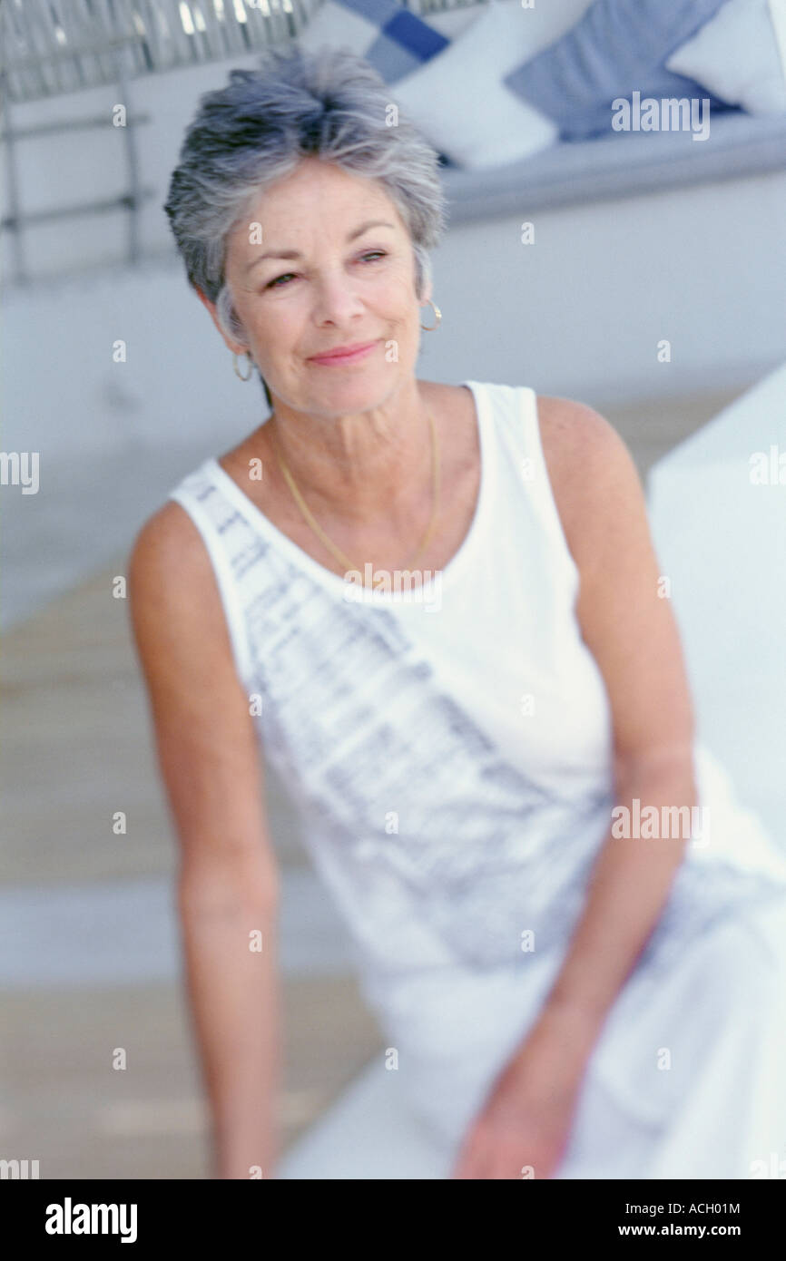 Portrait smiling thougtful woman on terrace Stock Photo - Alamy