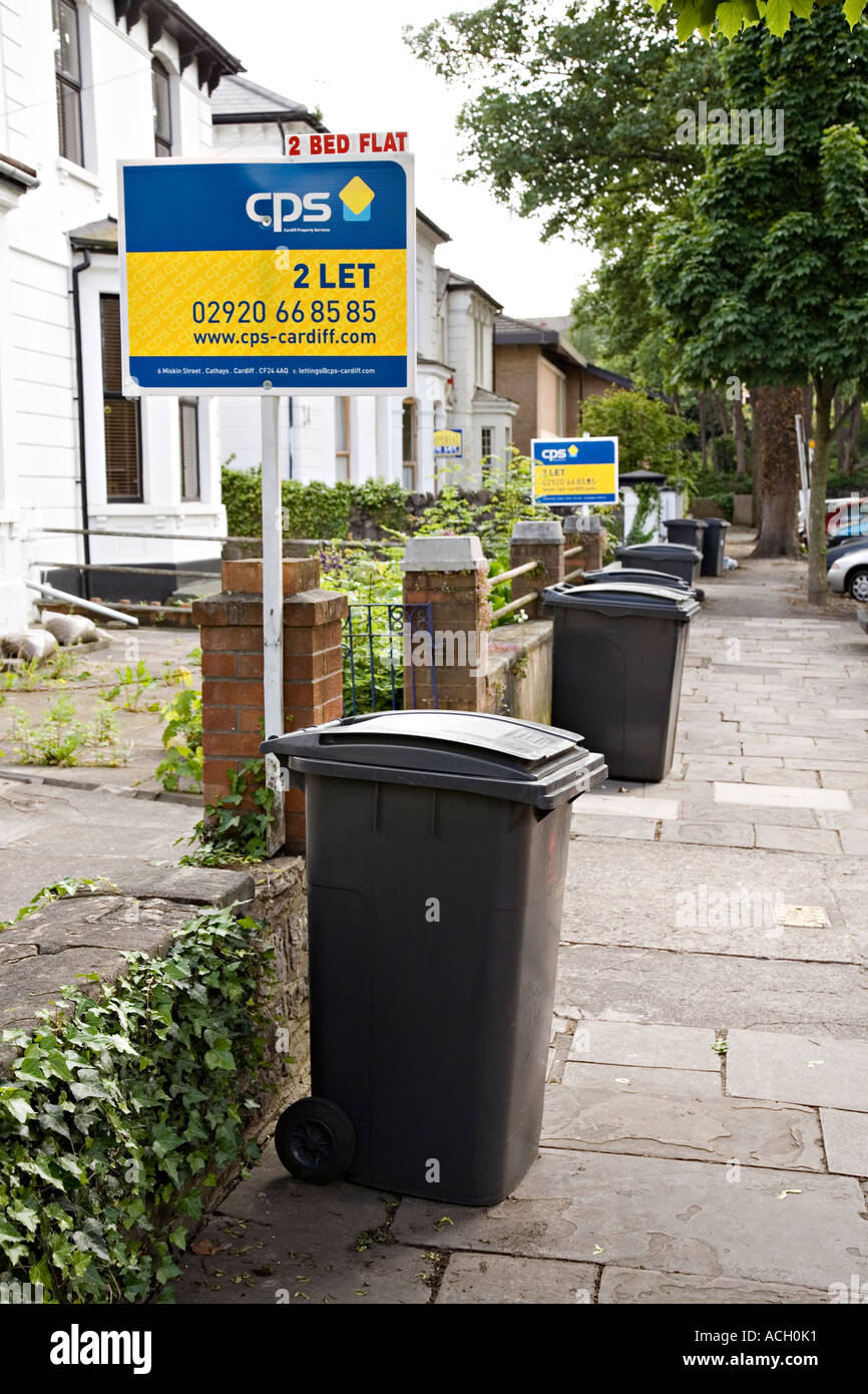 Wheely bins for refuse collection in residential street with flats to