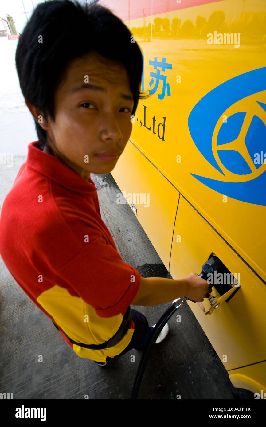 Gasoline Petrol Pump and Chinese Attendant Pumpoing Gas outside Shanghai China Stock Photo