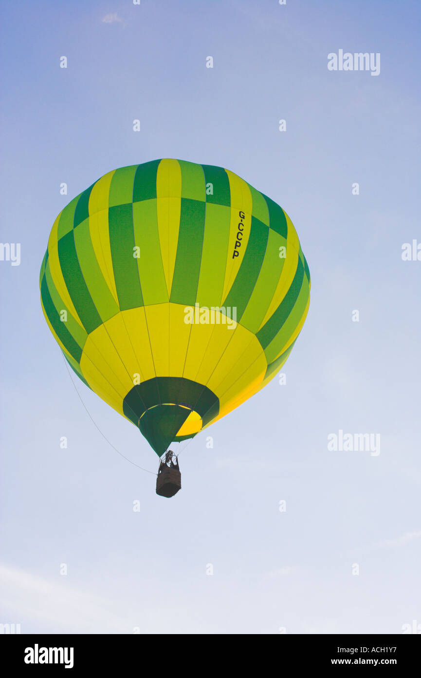 Hot air balloon against pale blue sky from underneath Stock Photo