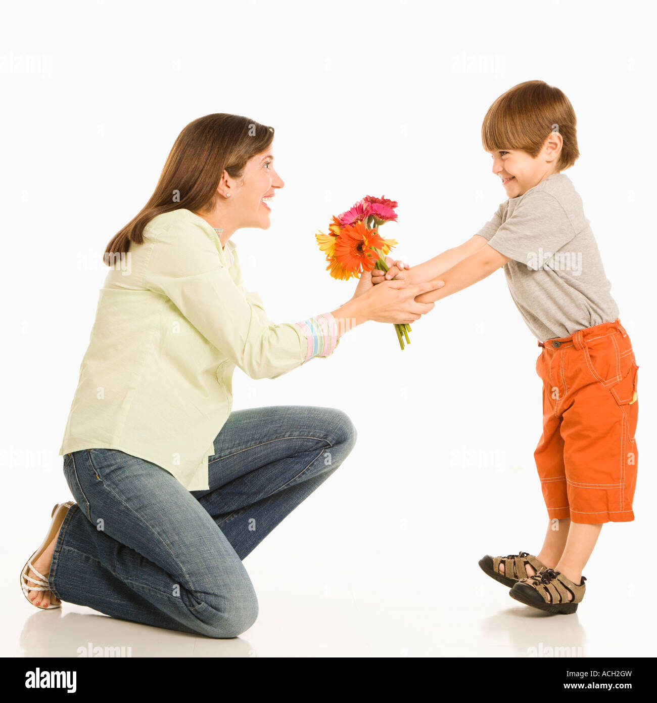 Son giving bouquet of flowers to mother Stock Photo Alamy