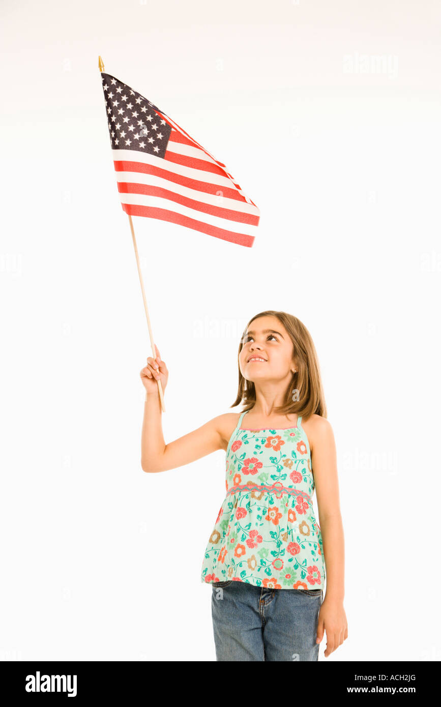 Girl holding American flag against white background Stock Photo - Alamy