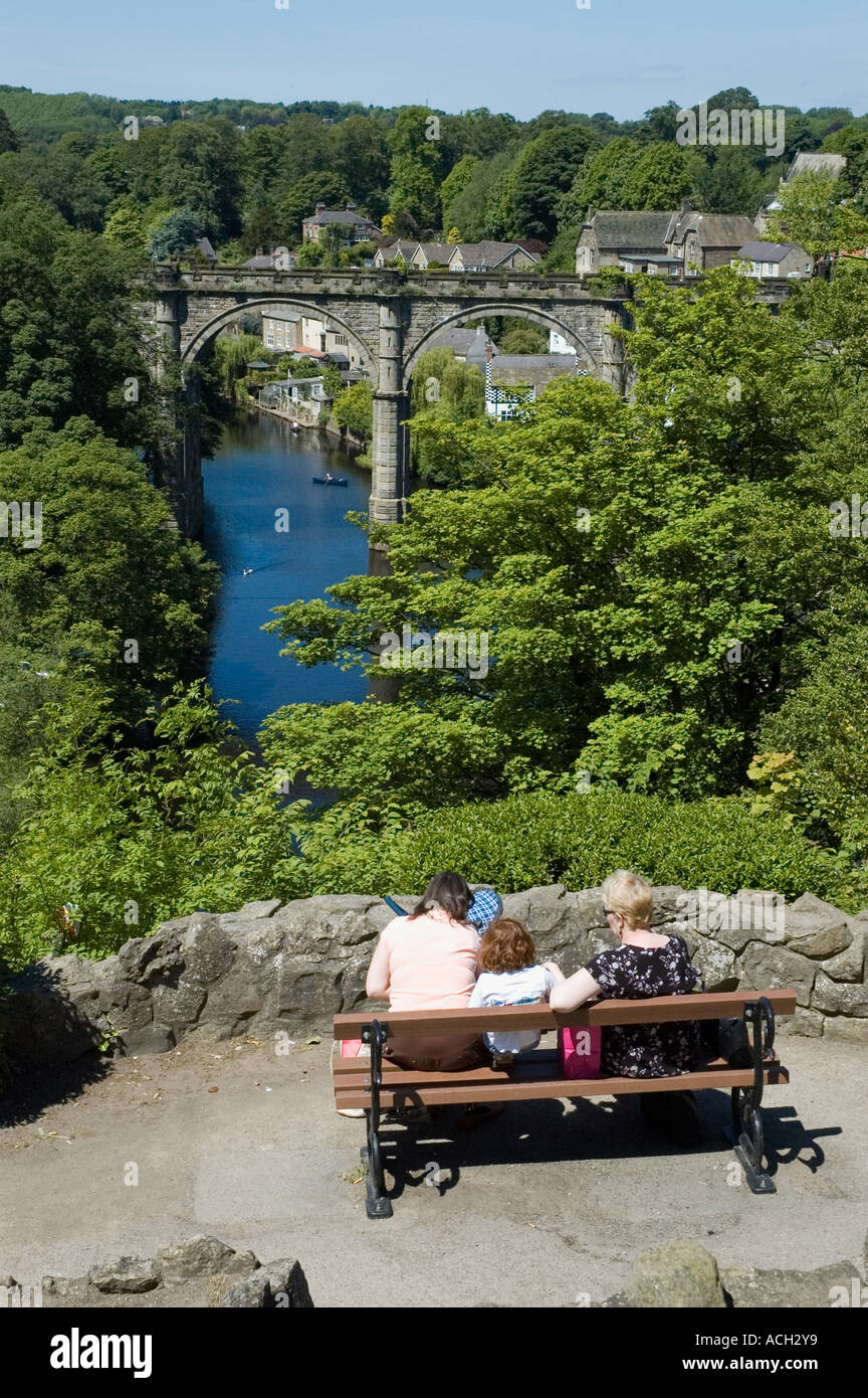 People enjoying the view of the River Nidd and the railway bridge Knaresborough North Yorkshire Stock Photo