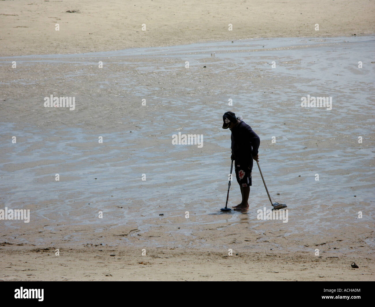 "Beach combing with a metal detector Stock Photo Alamy