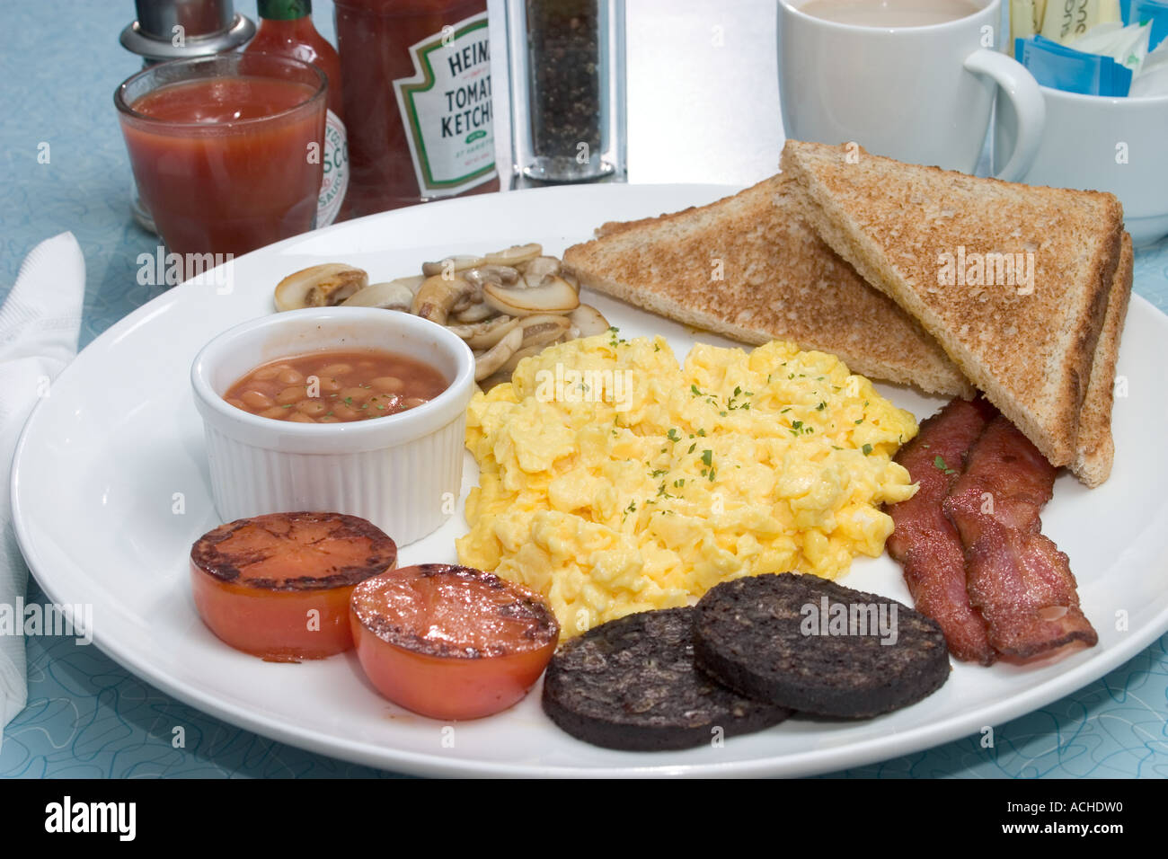 Set Breakfast Scrambled Eggs Bacon Black Pudding Grilled Tomato Baked Beans Mushrooms Coffee Juice Table Setting Brown Toast Stock Photo Alamy