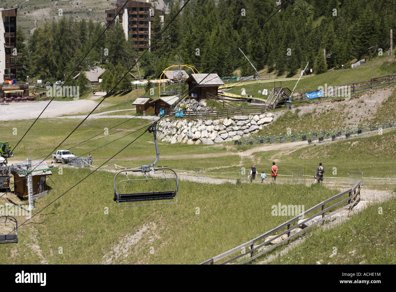 Tourists walking in a ski resort in summer, Les Orres, Hautes Alpes, France Stock Photo