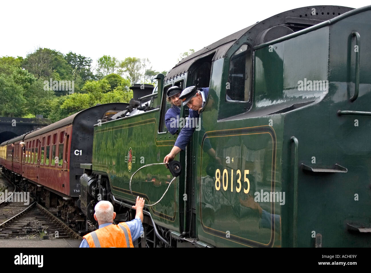 Train driver hands over line key to signalman at Grosmont steam railway