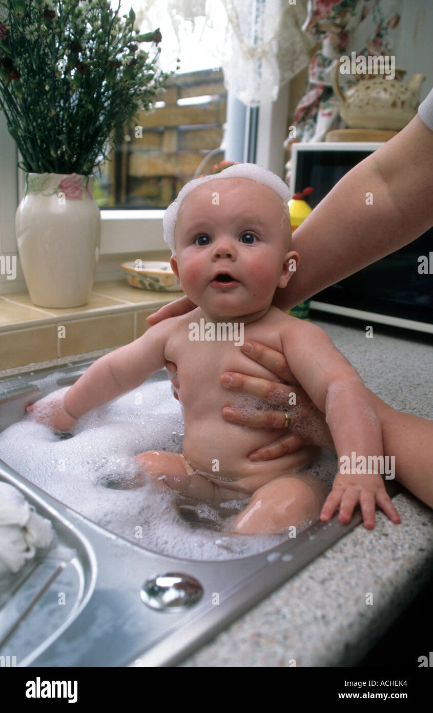 Baby Boy Having A Bath In A Kitchen Sink Stock Photo Alamy