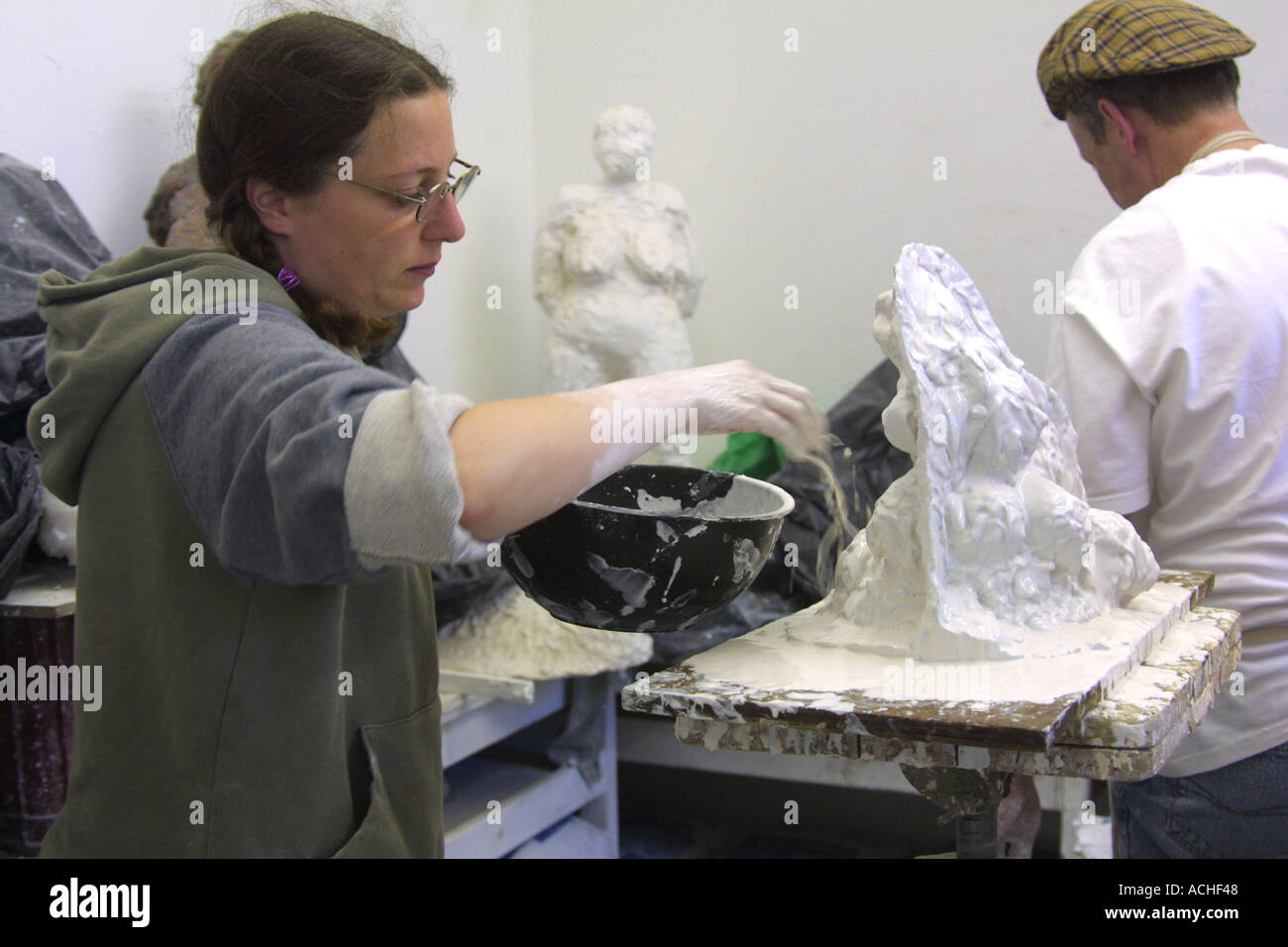 Mature female student in Clay sculpture class at London FE college