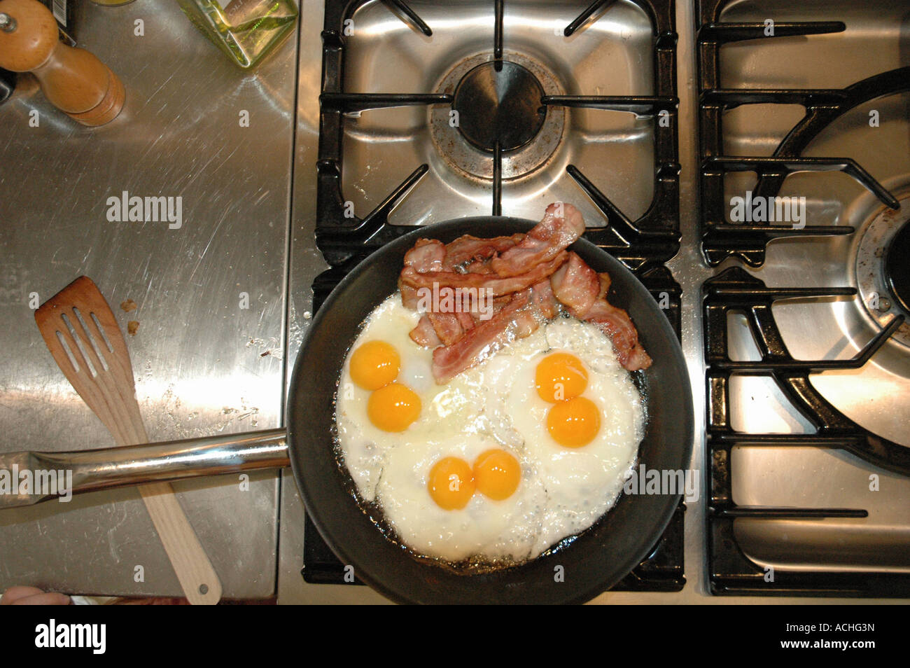 Bacon and eggs on professional cooking stove Stock Photo Alamy