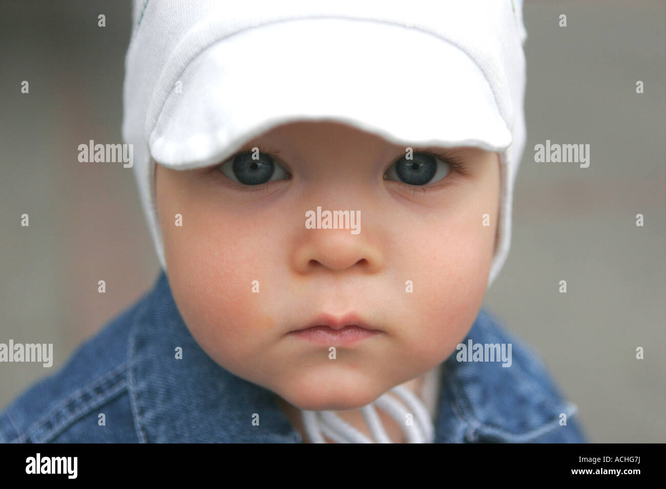 A little boy with white cap in jeans Portrait Stock Photo - Alamy