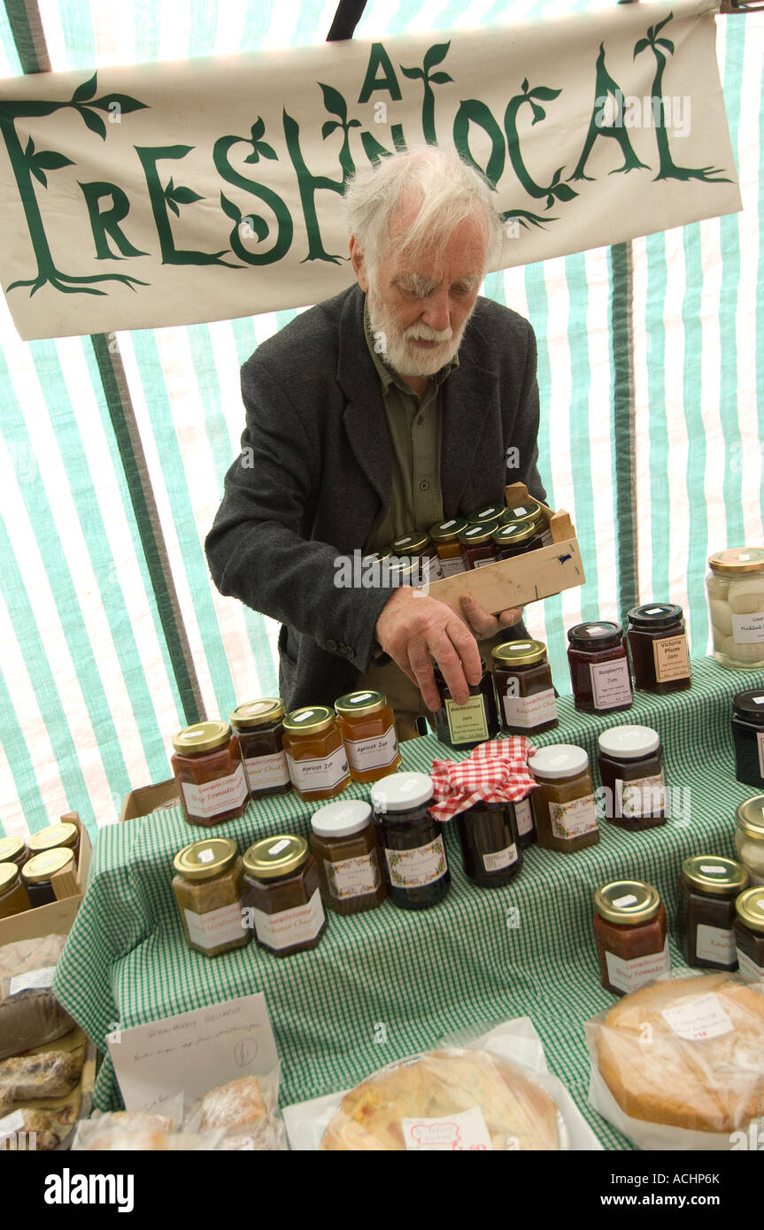 weekly Street Market Machynlleth Powys Mid wales July 2007 stall man selling fresh organic local made jams cake produce, Stock Photo