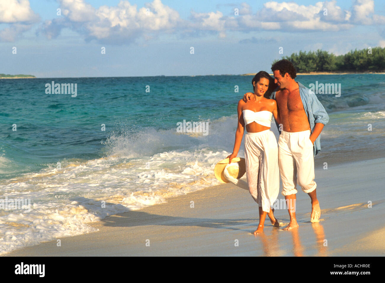 Romantic couple walking on beach Stock Photo