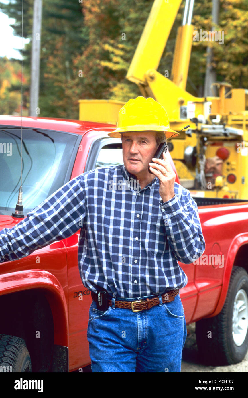 Construction worker talking on portable phone on job site Stock Photo