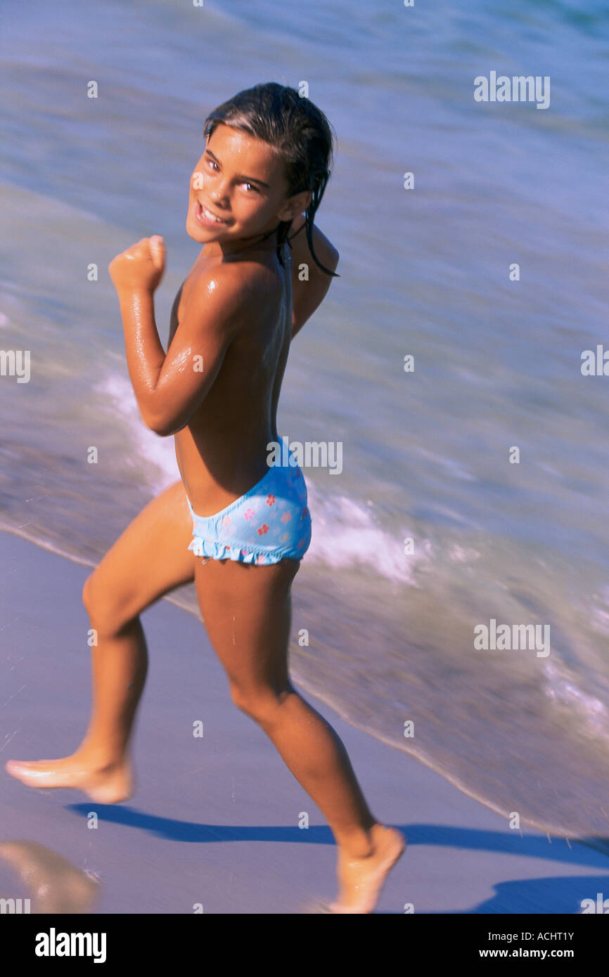 Elevated view on little girl in bikini running on the beach Stock Photo -  Alamy