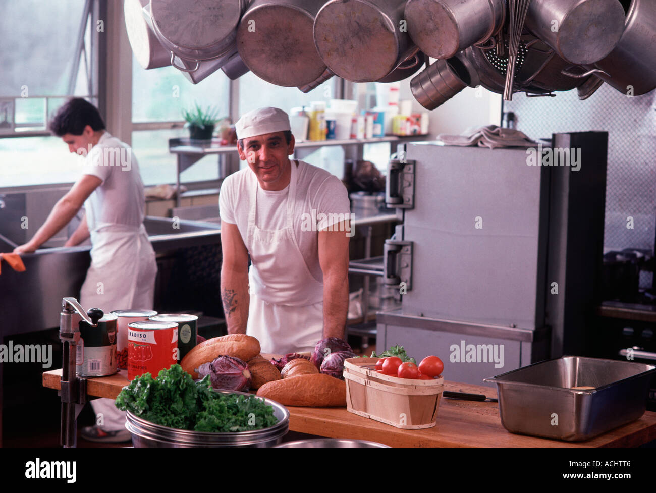 Two Caucasian food service workers in commercial kitchen Stock Photo