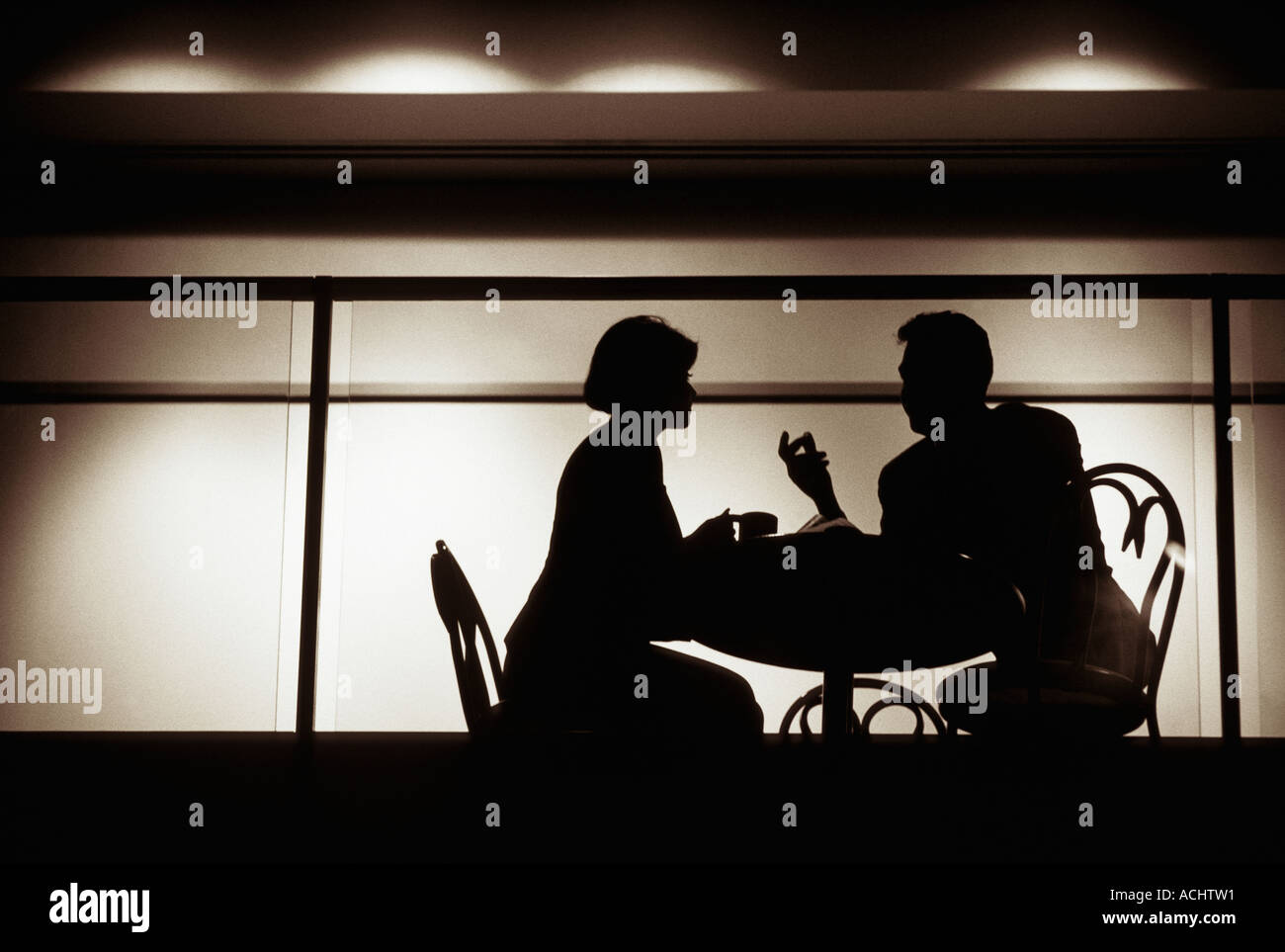 Couple talking in intimate nightclub setting Stock Photo