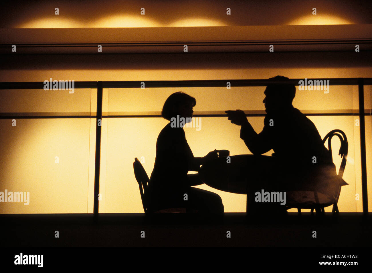 Couple talking in intimate nightclub setting Stock Photo