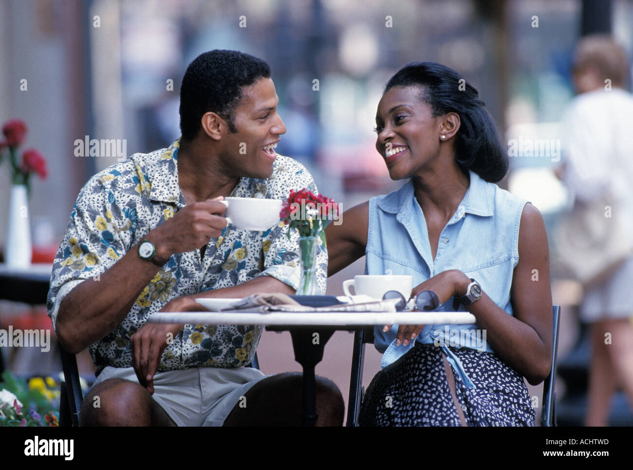 African American couple drinking coffee in outdoor cafe Stock Photo - Alamy