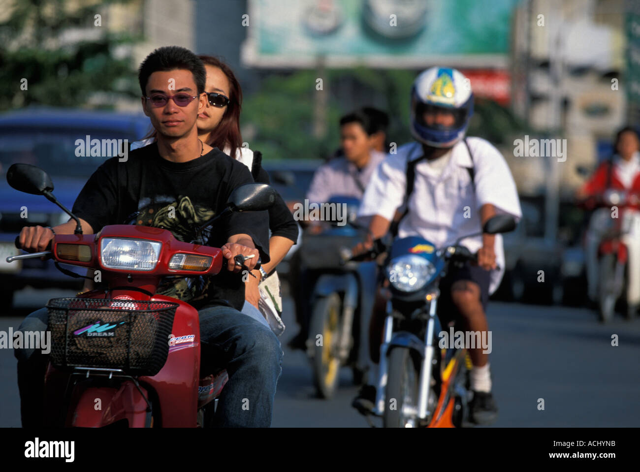 Thailand Chiang Mai Motor scooters drive through crowded downtown