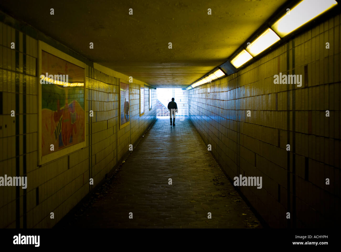 man Person walking alone in underpass subway in a city Stock Photo