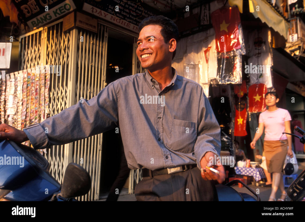 Asia Vietnam Hanoi Portrait of young man smoking cigarette by ...