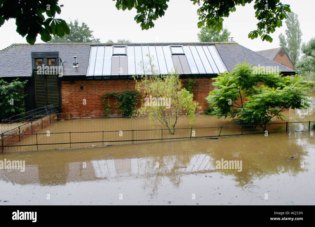 Flooded house and garden at Deerhurst Gloucestershire England UK caused by the rising River Severn after prolonged rainfall Stock Photo