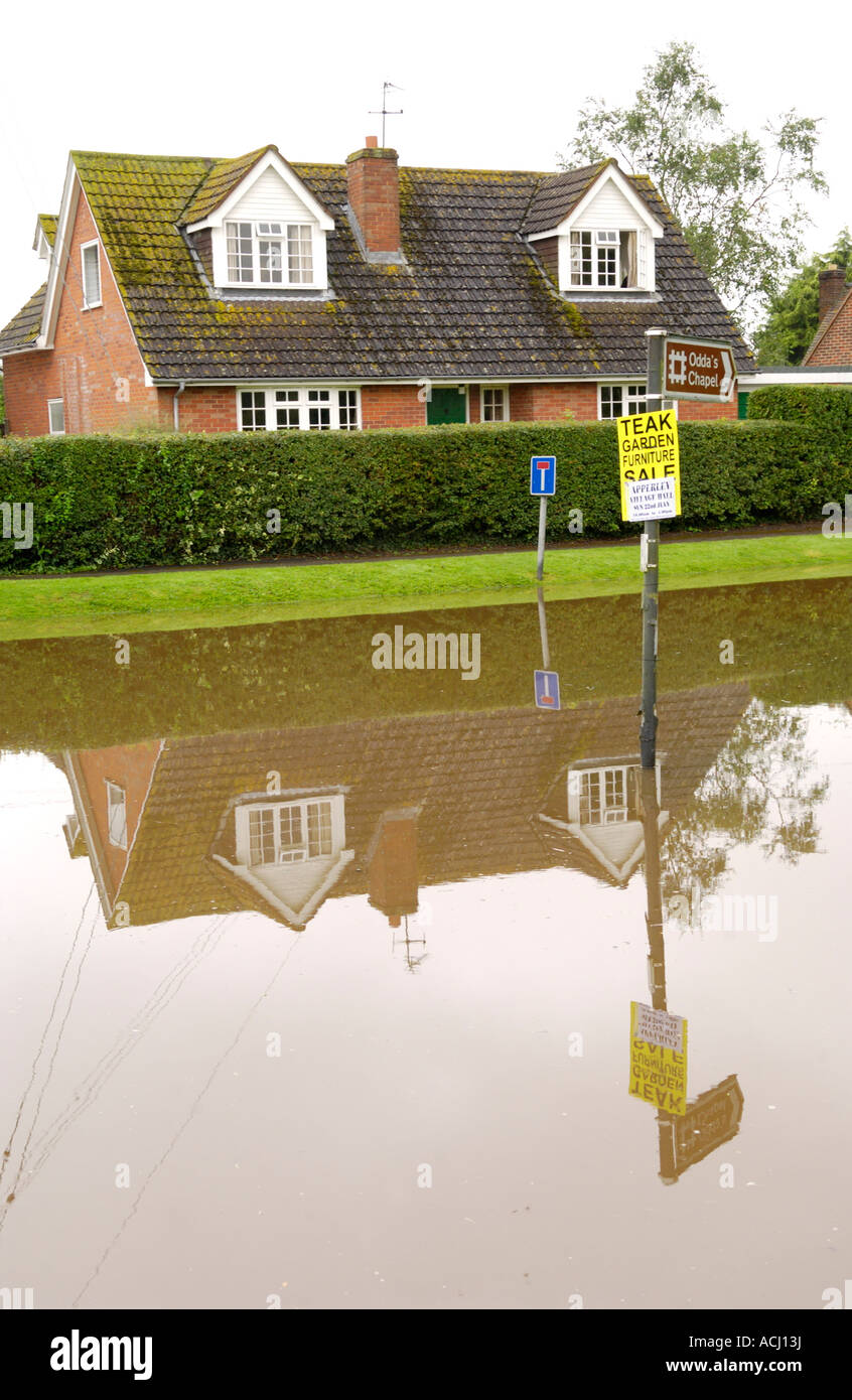 Flooded road in front of dormer bungalow at Deerhurst Gloucestershire England UK caused by the rising River Severn Stock Photo