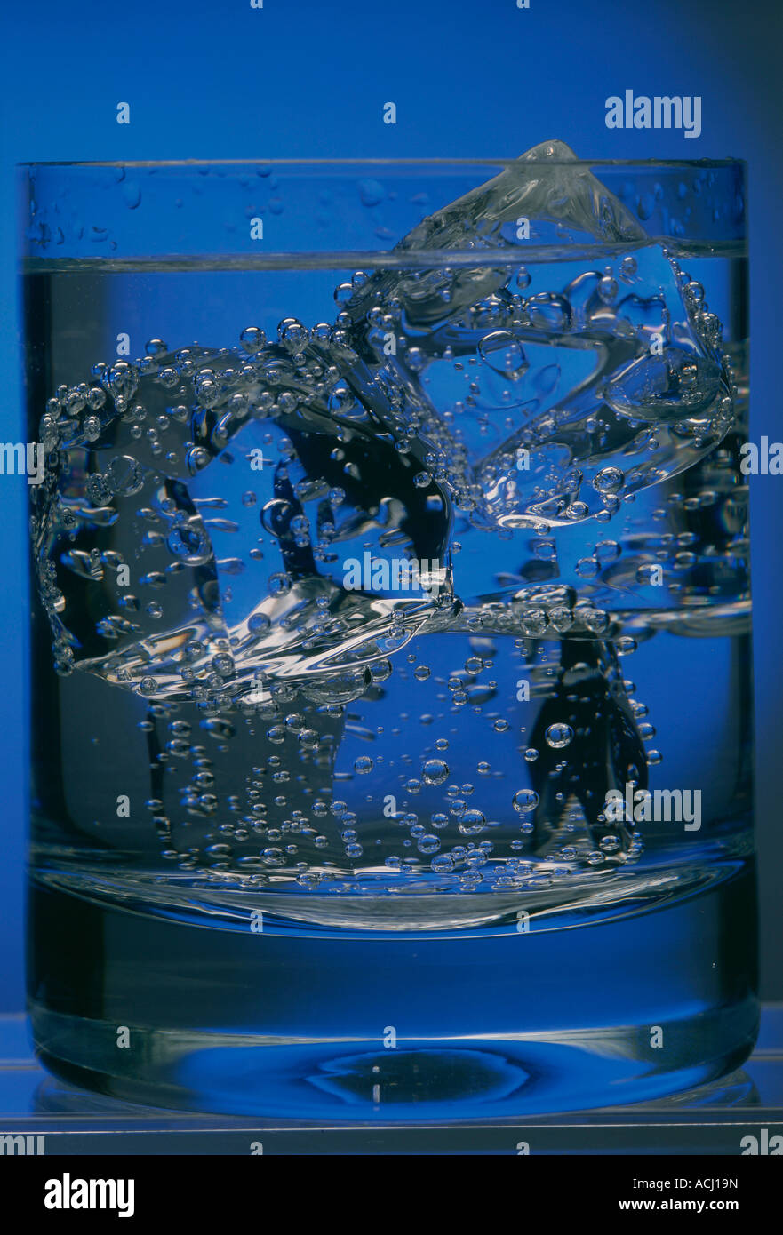 Glass of water with ice cubes bubbles Stock Photo - Alamy