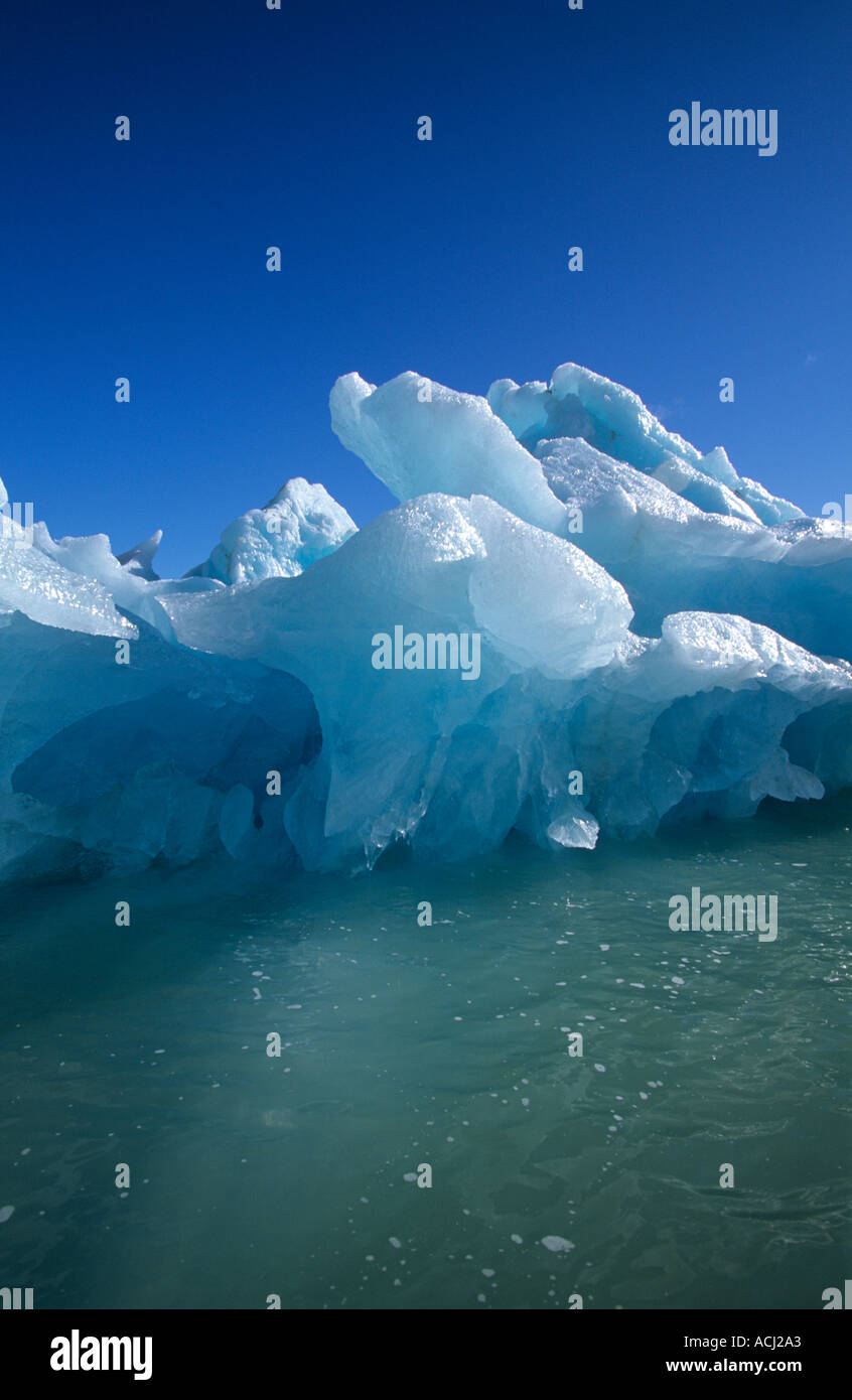 Blue ice Iceberg calved from glacier floating in the Arctic Ocean near Svalbard Stock Photo