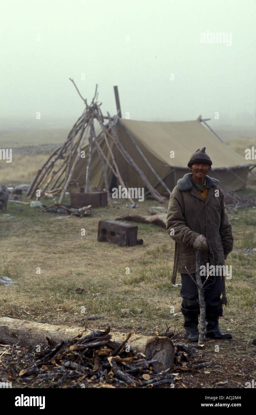 Russia Koryuk Reindeer herder with firewood by tent in Russian Far Easts Taygonos Peninsula Stock Photo